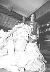 Photo of student with laundry pile