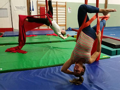 Photo of students practicing aerial silks techniques