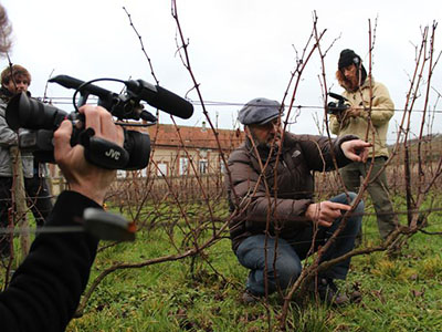 Photo of students filming winemaker in France